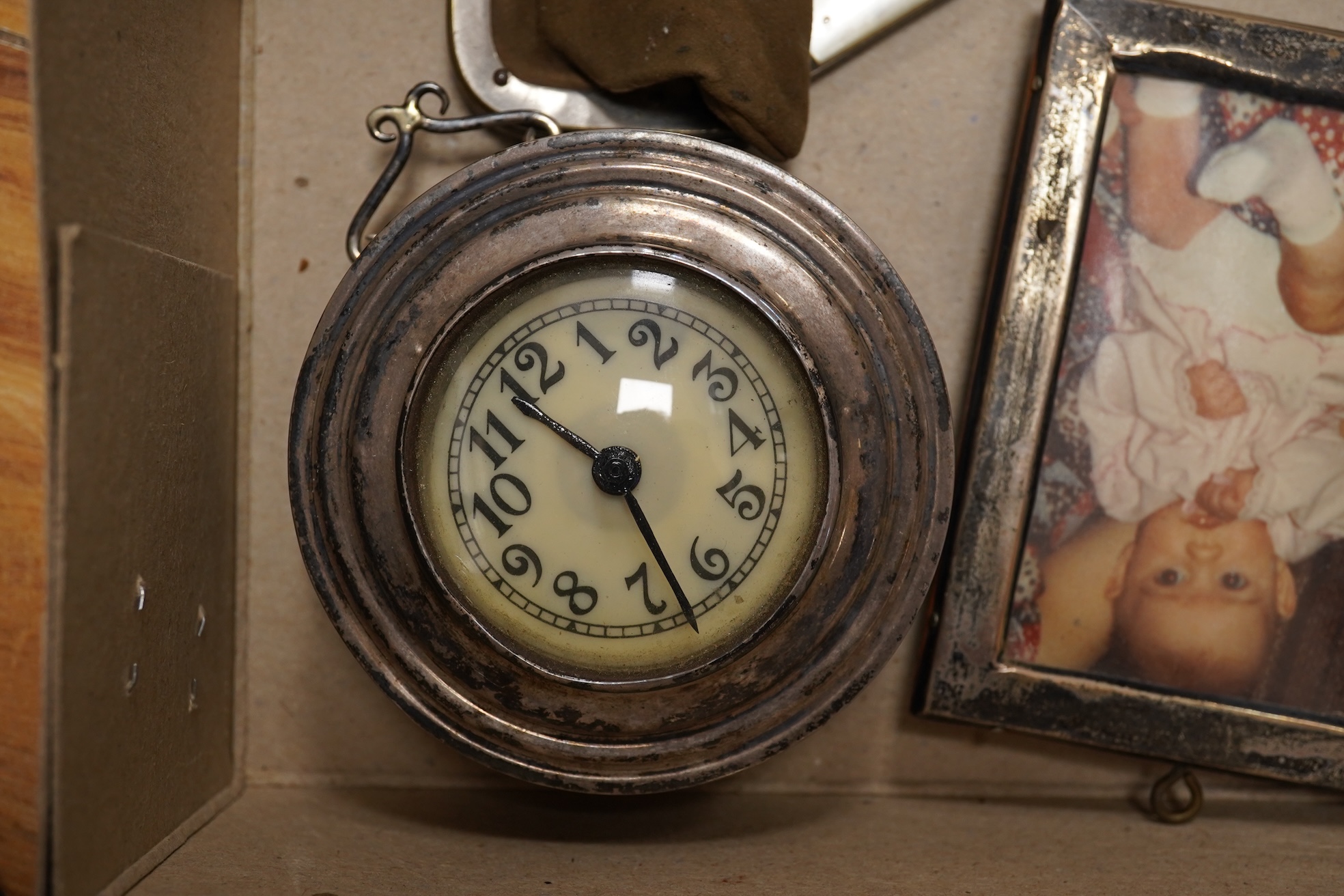 A collection of objects of vertu including snuff boxes, a pair of miniature oval trays, a silver mounted clock and photo frame, etc.
